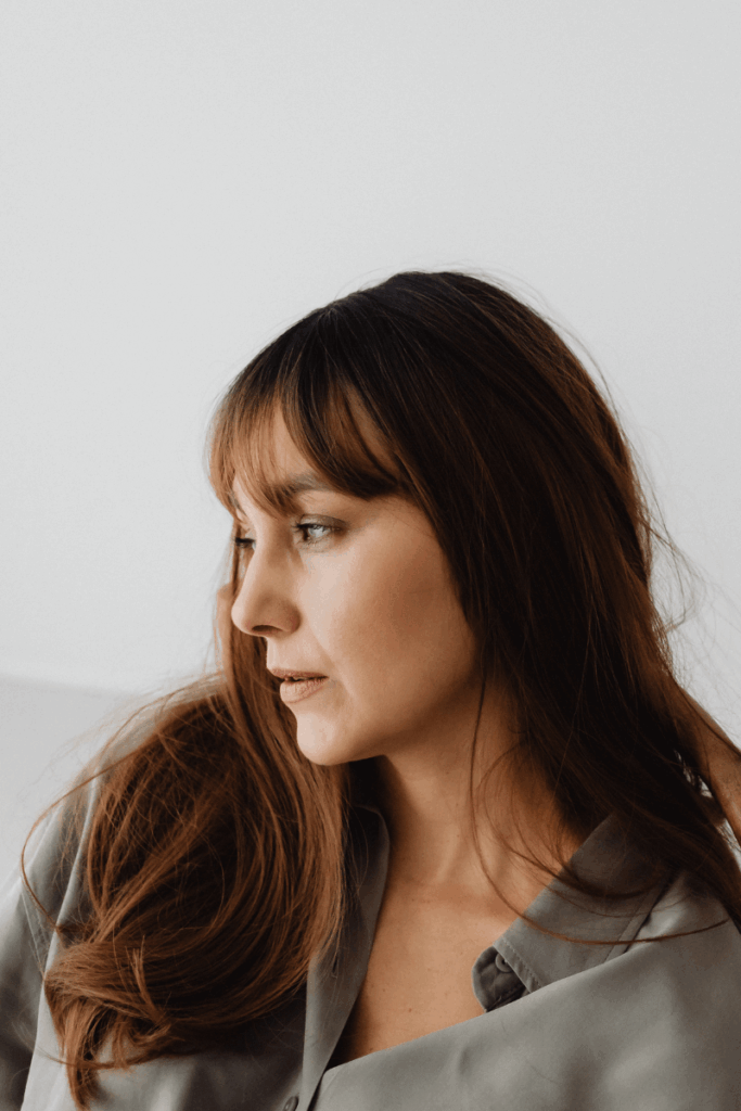 An under-resourced woman sitting and thinking.