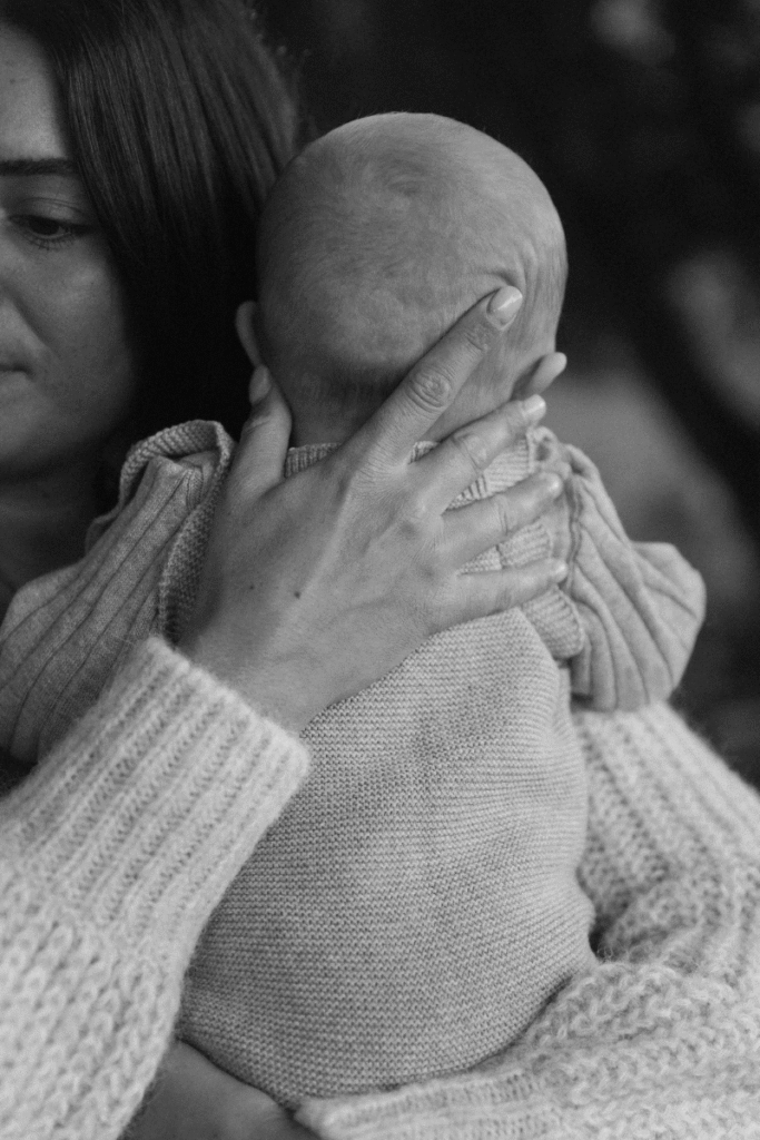 Mother holding newborn baby, illustrating the connection between preconception health, fertility preparation, and maternal wellness for TTC.