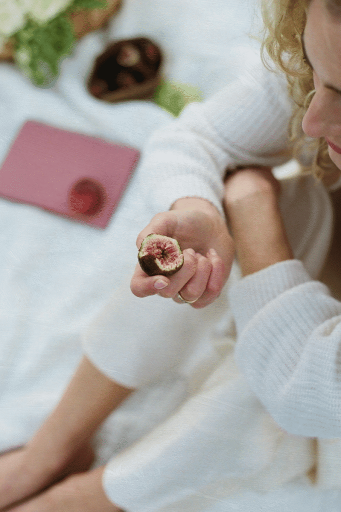 Woman enjoying fresh fruit while exploring proactive ways to support fertility at 35 beyond freezing your eggs.